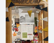 interior door with "hello" sign next to various informational flyers and posters